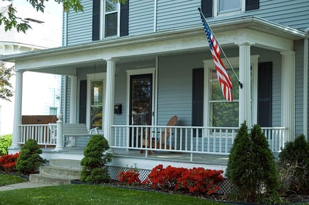 Massachusetts home with a farmer's porch and American flag