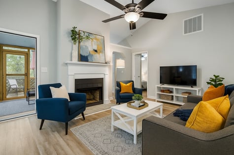 Living room with a fireplace and slider to three-season porch