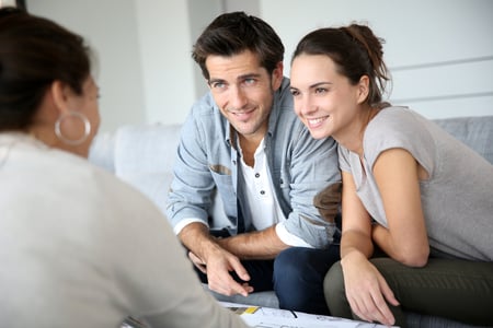 Couple meeting real estate buyer agent to learn about homebuying