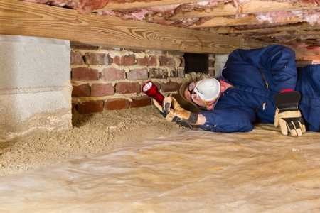 Home Inspector in Crawl Space Performing a Home Inspection in Massachusetts