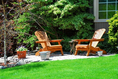 Comfortable and pleasant backyard at home with wooden chairs.