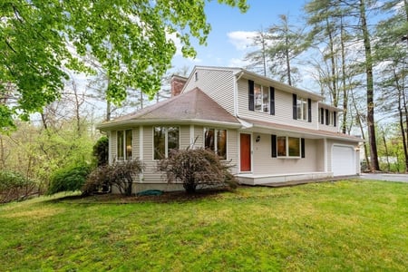 Tan colonial with a one-car garage. 